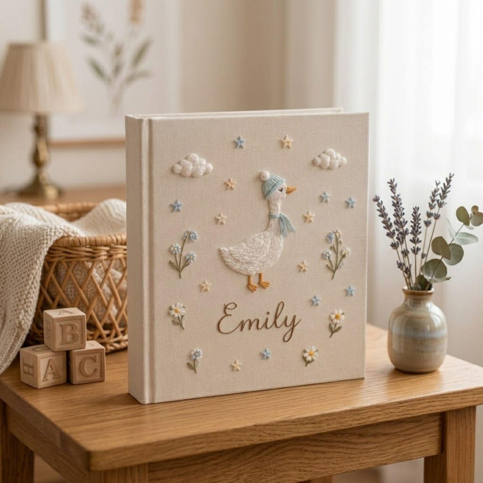 Personalized goose hand embroidered baby photo album with pastel balloons and floral meadow design on linen cover