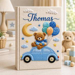 Personalized hand embroidered baby photo album featuring teddy bear on vintage blue car with balloons, moon, stars, and custom name embroidery