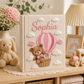 Personalized hand embroidered baby photo album with teddy bear in pink hot air balloon and fluffy embroidered clouds