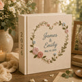 Personalized embroidered wedding photo album with floral heart wreath, pastel flower embroidery, custom names, wedding date, and linen hardcover design