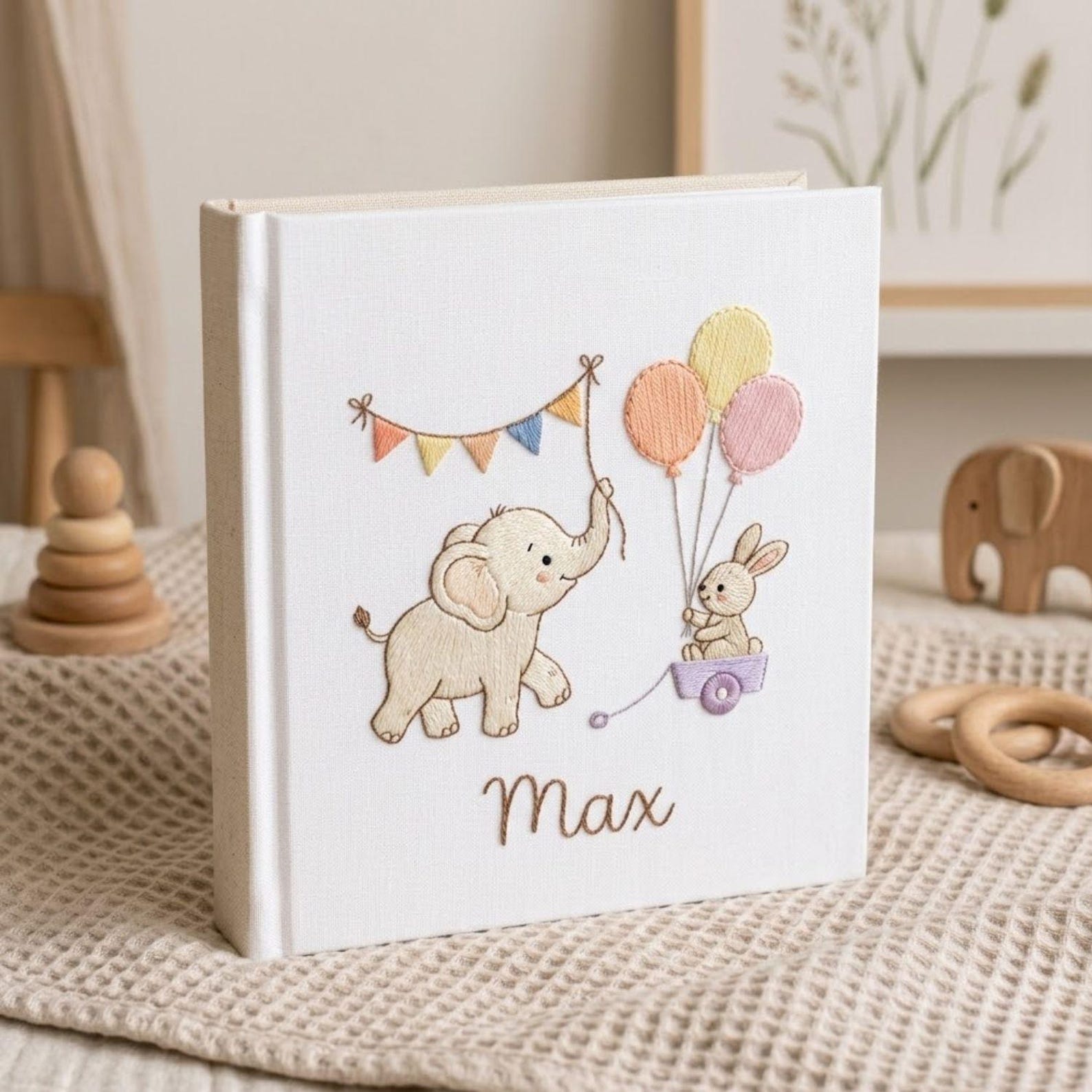 Personalized embroidered baby photo album with elephant, bunny, pastel balloons, and custom name embroidery