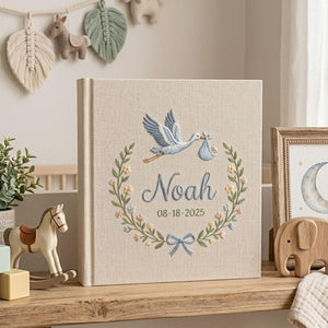 Personalized stork birth announcement embroidered baby photo album with custom name and birth date on linen cover