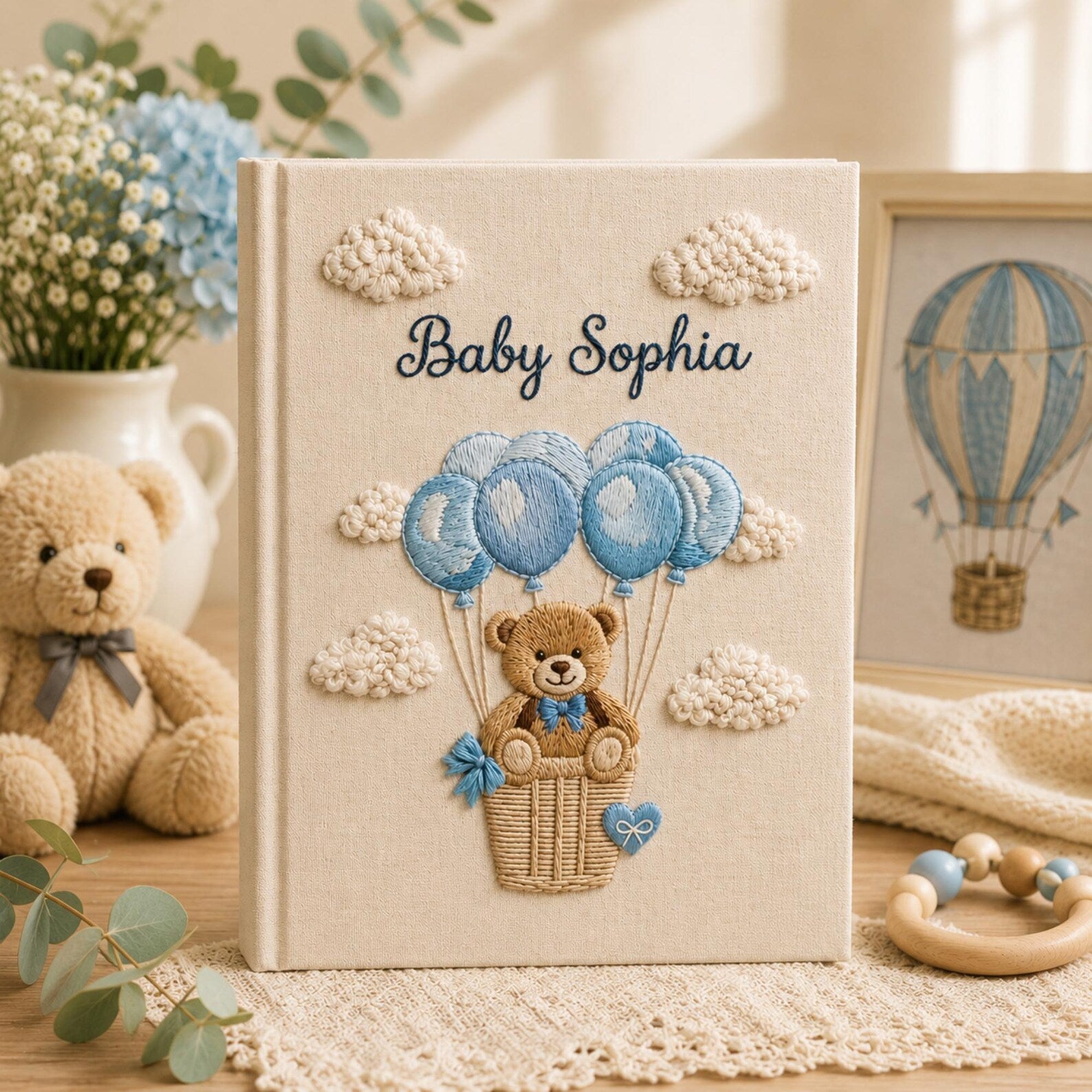 Personalized embroidered baby photo album with teddy bear in balloon basket and blue cloud nursery design