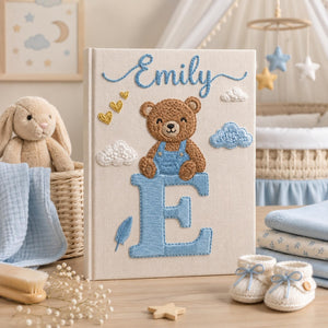 Personalized hand embroidered baby photo album with teddy bear sitting on monogram letter E