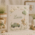 Personalized hand embroidered photo album featuring a vintage sage green pickup truck, floating teddy bear with balloons, clouds, and wildflowers on a premium linen cover customized with a baby name