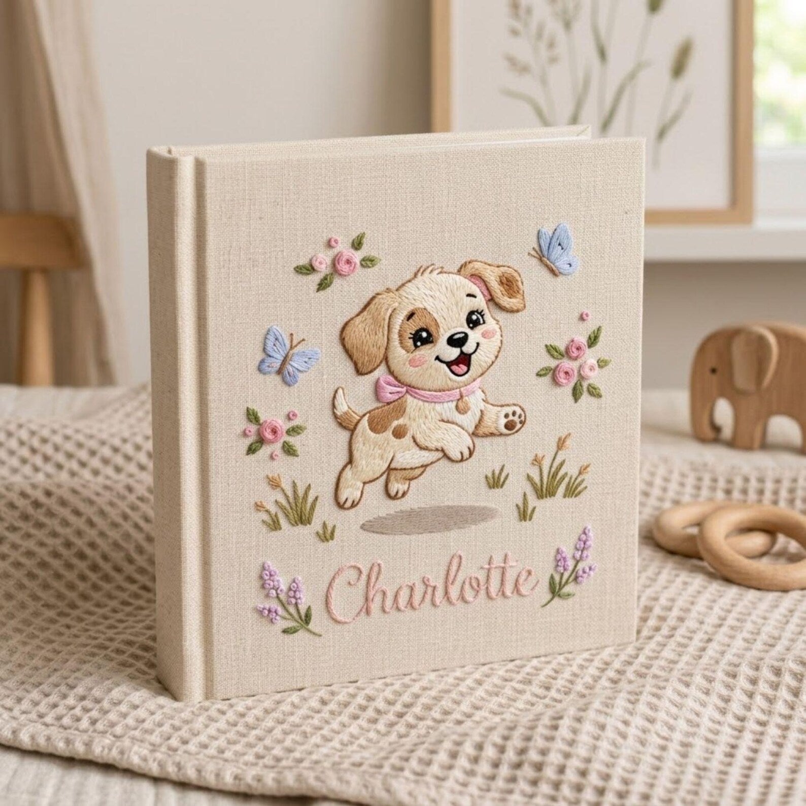 Personalized embroidered baby photo album with cute puppy, butterflies, pastel flowers, and custom name embroidery