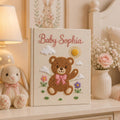 Personalized embroidered baby photo album with teddy bear, sunshine, clouds, and pastel flowers nursery design