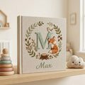 Personalized woodland fox monogram embroidered baby photo album with forest leaves and custom name on linen cover
