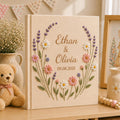 Personalized embroidered wedding photo album with lavender stems pastel daisies and custom couple names on linen cover