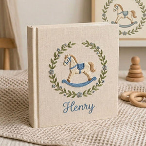 Personalized hand embroidered baby photo album with rocking horse and botanical wreath nursery design