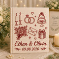 Personalized embroidered wedding photo album with wedding rings, cake, candles, flowers, custom names, and wedding date on linen hardcover