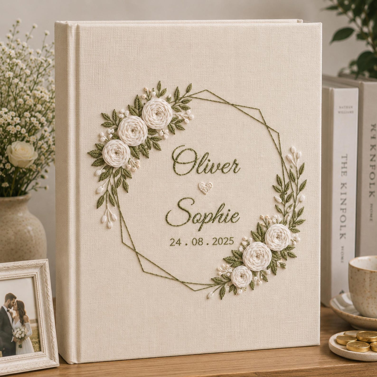 Personalized embroidered wedding photo album with white roses geometric floral wreath and custom couple names on linen cover