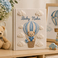 Personalized embroidered baby photo album with teddy bear in blue sky balloon basket and fluffy cloud embroidery