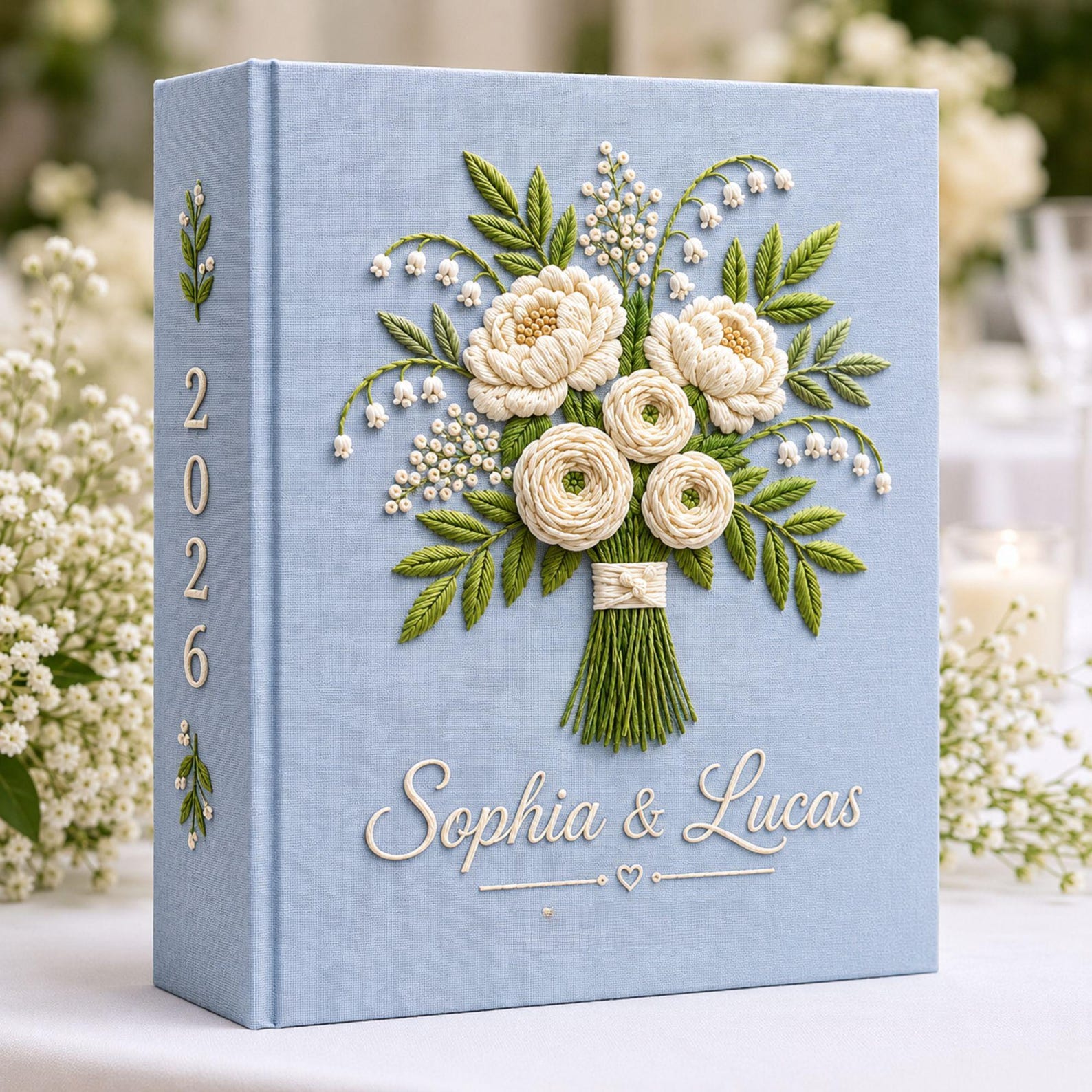 Personalized white floral bouquet hand embroidered photo album with custom names on blue linen wedding keepsake cover