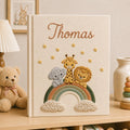 Personalized hand embroidered baby photo album with safari animals sitting on rainbow