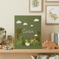 Personalized dinosaur hand embroidered baby photo album with cute prehistoric nursery design on green linen cover