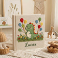Personalized dinosaur hand embroidered baby photo album with colorful balloons and custom name on linen cover