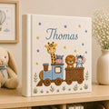 Personalized hand embroidered photo album featuring a safari animal train with giraffe, hippo, lion and zebra on a linen cover