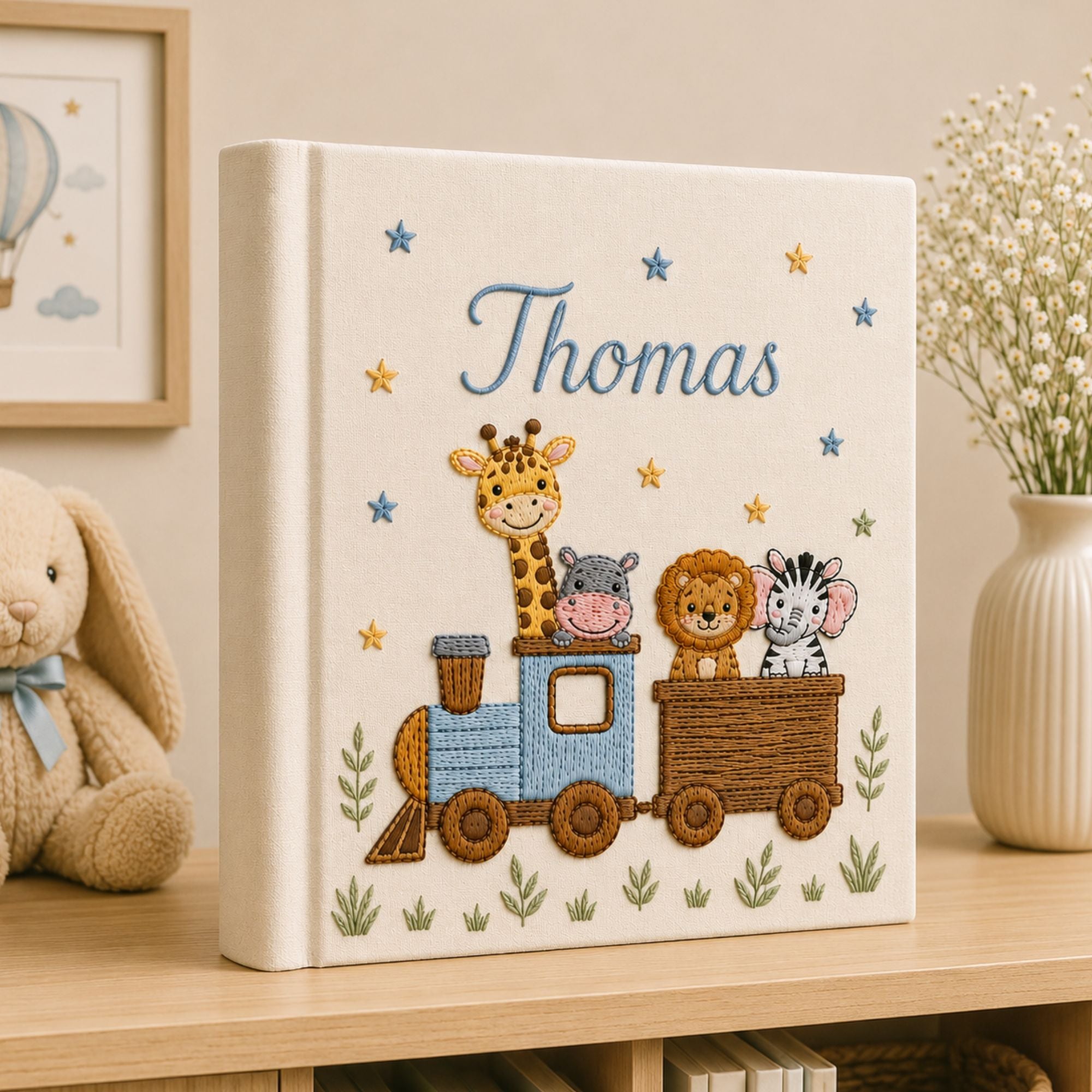 Personalized hand embroidered photo album featuring a safari animal train with giraffe, hippo, lion and zebra on a linen cover
