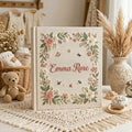 Personalized hand embroidered photo album featuring a floral garden wreath with bees, butterflies, delicate flowers and custom embroidered name on linen cover