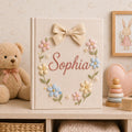 Personalized hand embroidered baby photo album with pastel floral wreath embroidery and elegant linen bow detail