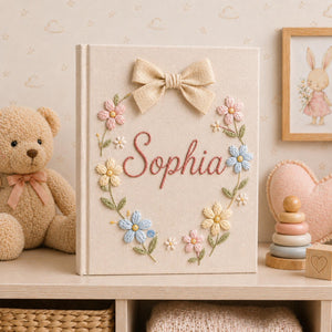 Personalized hand embroidered baby photo album with pastel floral wreath embroidery and elegant linen bow detail