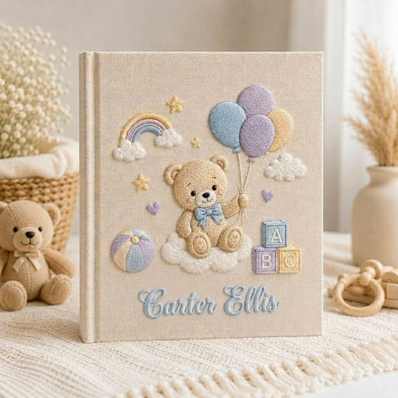 Personalized hand embroidered photo album featuring teddy bear holding pastel balloons with rainbow clouds ABC blocks and custom baby name