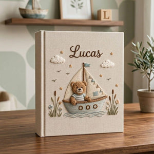 Personalized teddy sailboat hand embroidered baby photo album with nautical coastal nursery design on linen cover