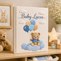 Personalized hand embroidered baby photo album with teddy bear holding blue balloons on clouds