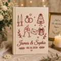 Personalized embroidered wedding photo album with wedding icons rings champagne cake and custom couple names on linen cover