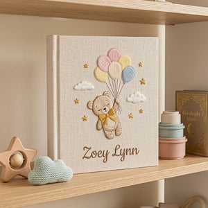 Personalized hand embroidered photo album featuring a floating teddy bear holding pastel balloons with custom baby name embroidery