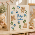 Personalized hand embroidered photo album featuring teddy bears, botanical flowers, leafy accents and custom baby name embroidery on a linen cover