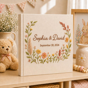 Collection of personalized hand embroidered floral wedding photo albums with botanical embroidery, custom couple names, and romantic linen covers