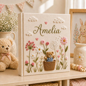 Personalized hand embroidered baby photo album with teddy bear basket wildflowers and cottagecore floral details