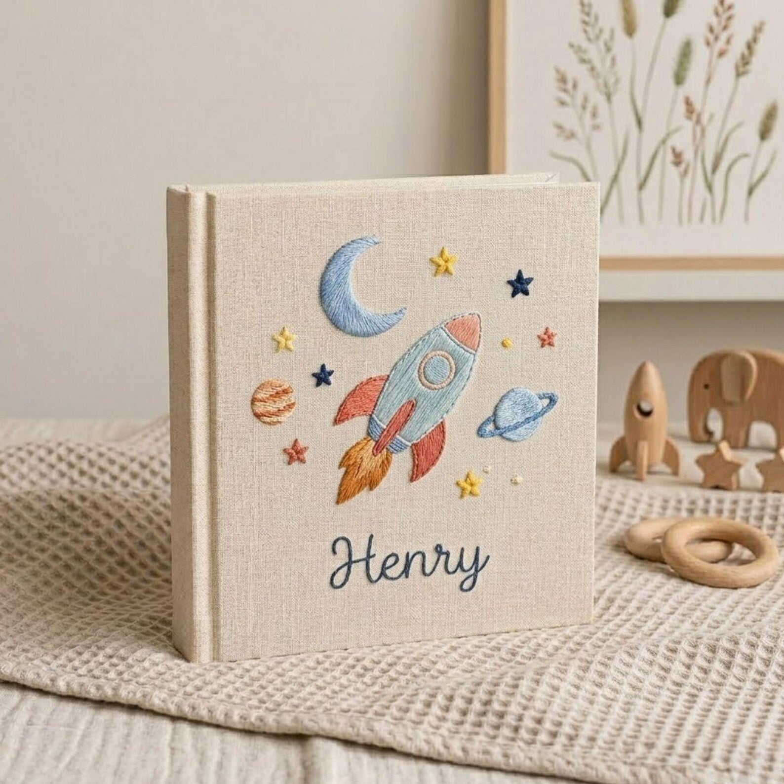 Personalized embroidered baby photo album with space rocket, moon, planets, stars, and custom name embroidery
