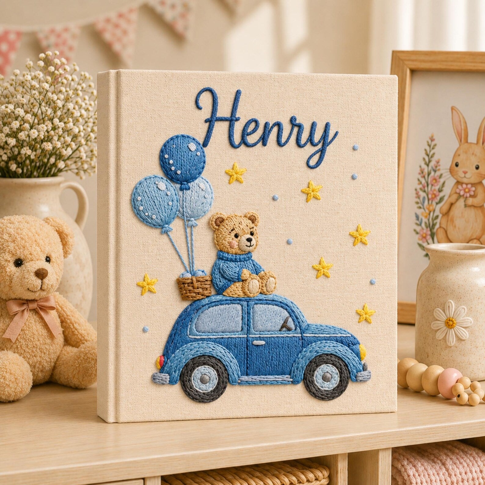 Personalized hand embroidered baby photo album featuring teddy bear riding a blue vintage car with balloons and stars on linen cover