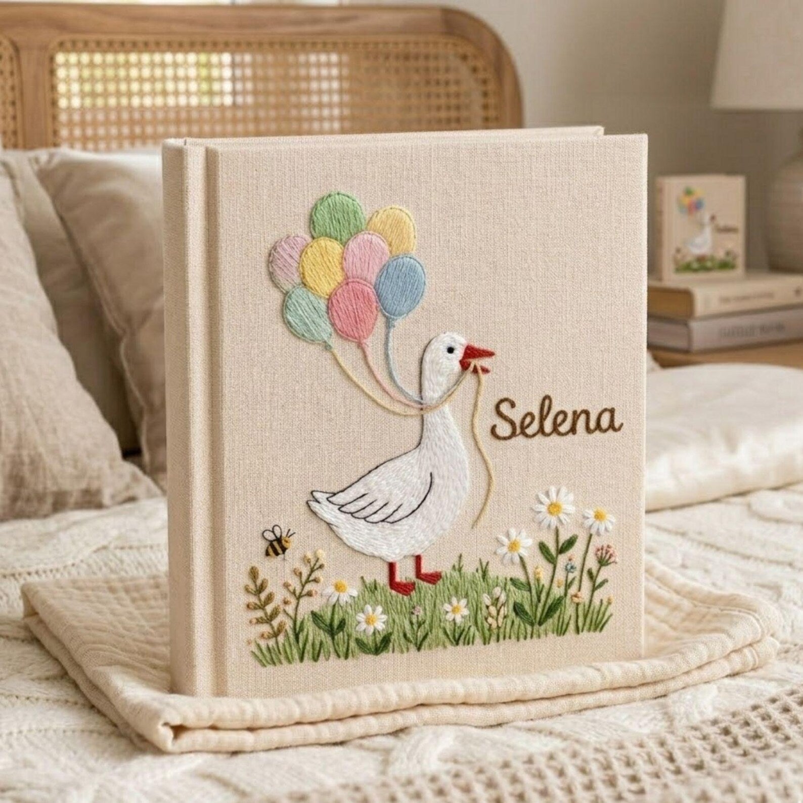 Personalized goose hand embroidered baby photo album with pastel balloons and floral meadow design on linen cover