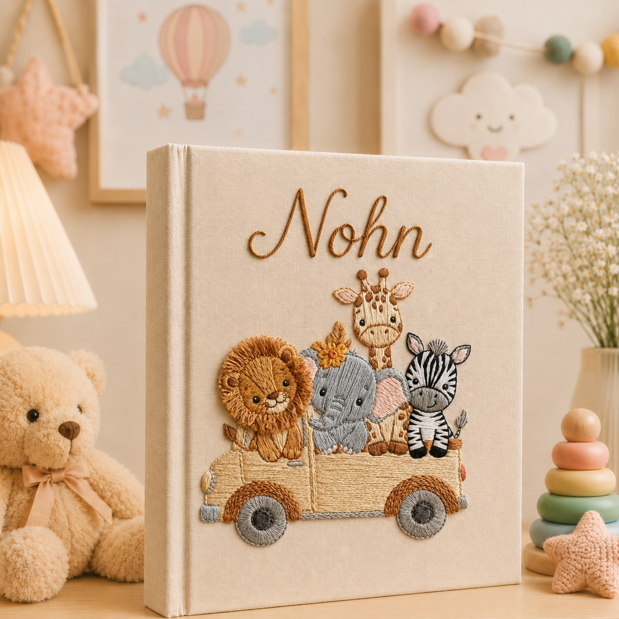 Personalized hand embroidered photo album featuring safari animals including a lion elephant giraffe and zebra riding together in a wooden wagon on a linen cover