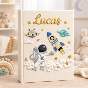 Personalized hand embroidered photo album featuring astronaut rocket planets stars and custom baby name on linen cover