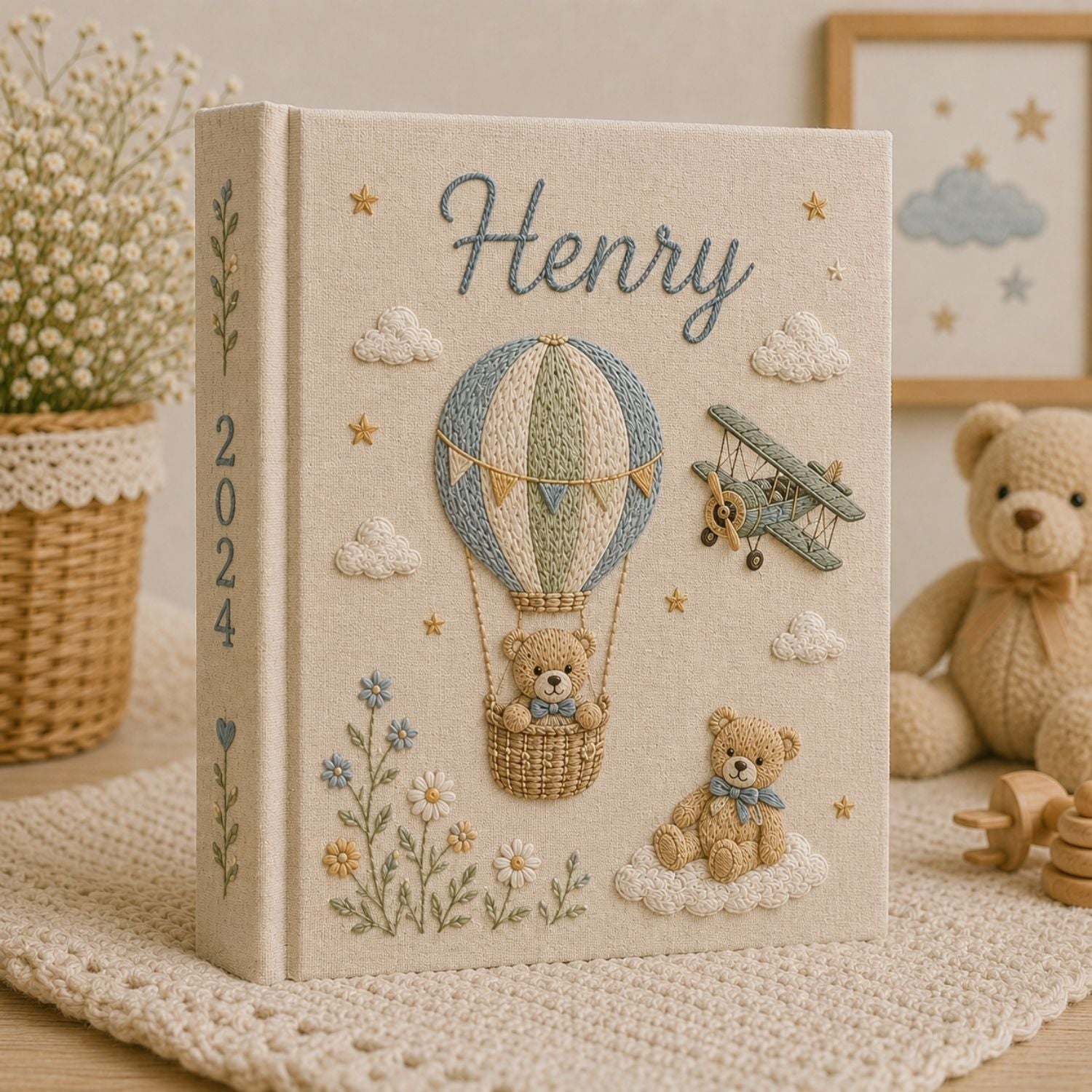 Personalized hand embroidered photo album featuring a teddy bear in a vintage hot air balloon with a classic biplane, clouds, stars, wildflowers, custom name and year embroidery on a premium linen cover