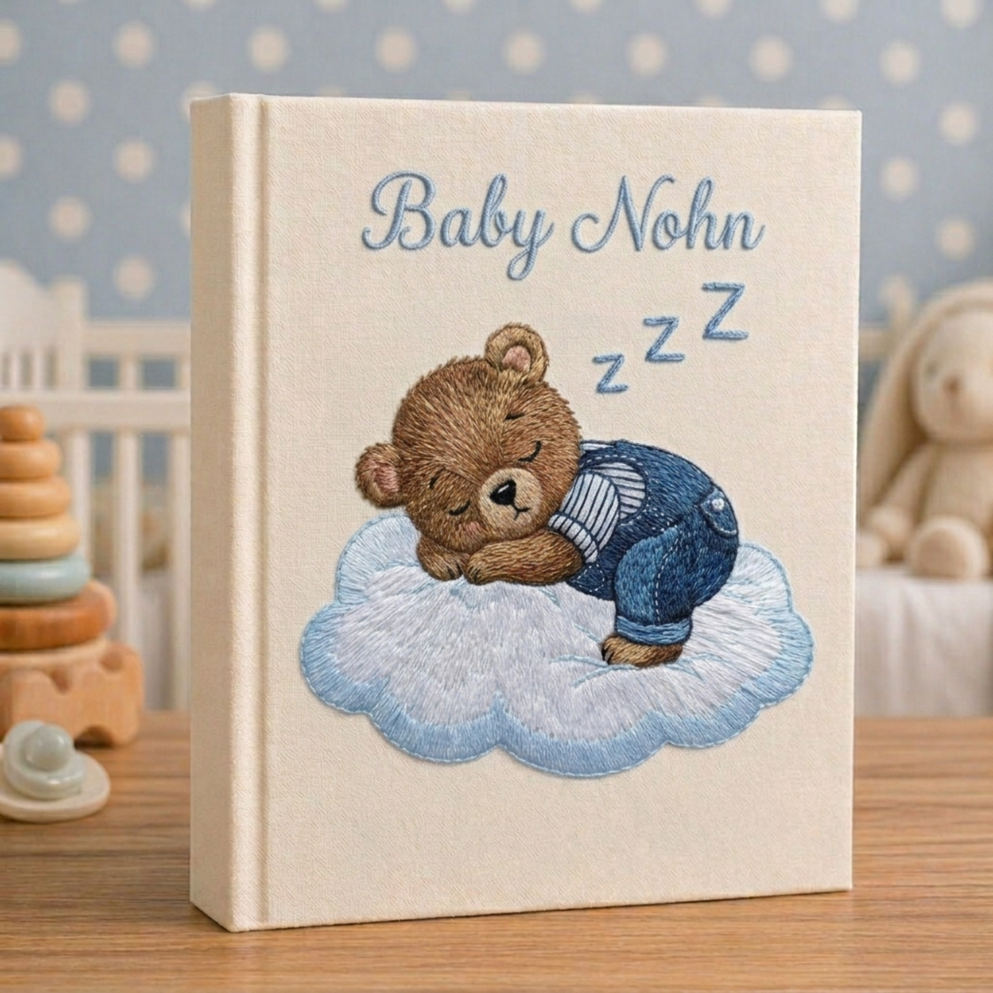 Personalized hand embroidered photo album featuring a sleeping teddy bear resting on a fluffy cloud in a dreamy nursery theme