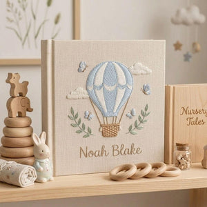 Personalized hand embroidered photo album featuring a blue hot air balloon with butterflies clouds and custom baby name