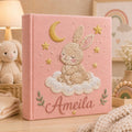 Personalized hand embroidered baby photo album with sleepy bunny, crescent moon, stars, and fluffy cloud embroidery details