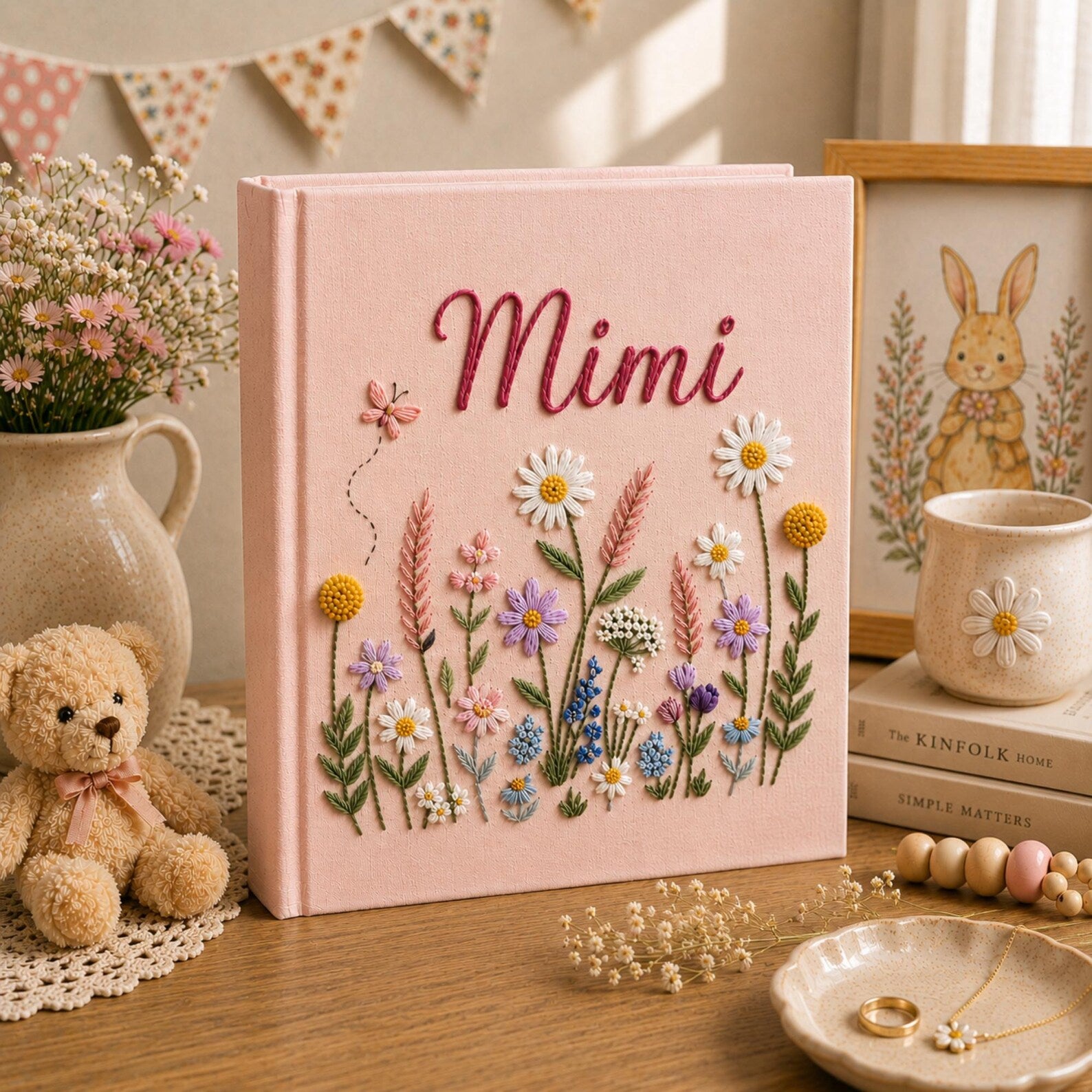 Personalized pink embroidered baby photo album with colorful wildflower garden design and custom name embroidery