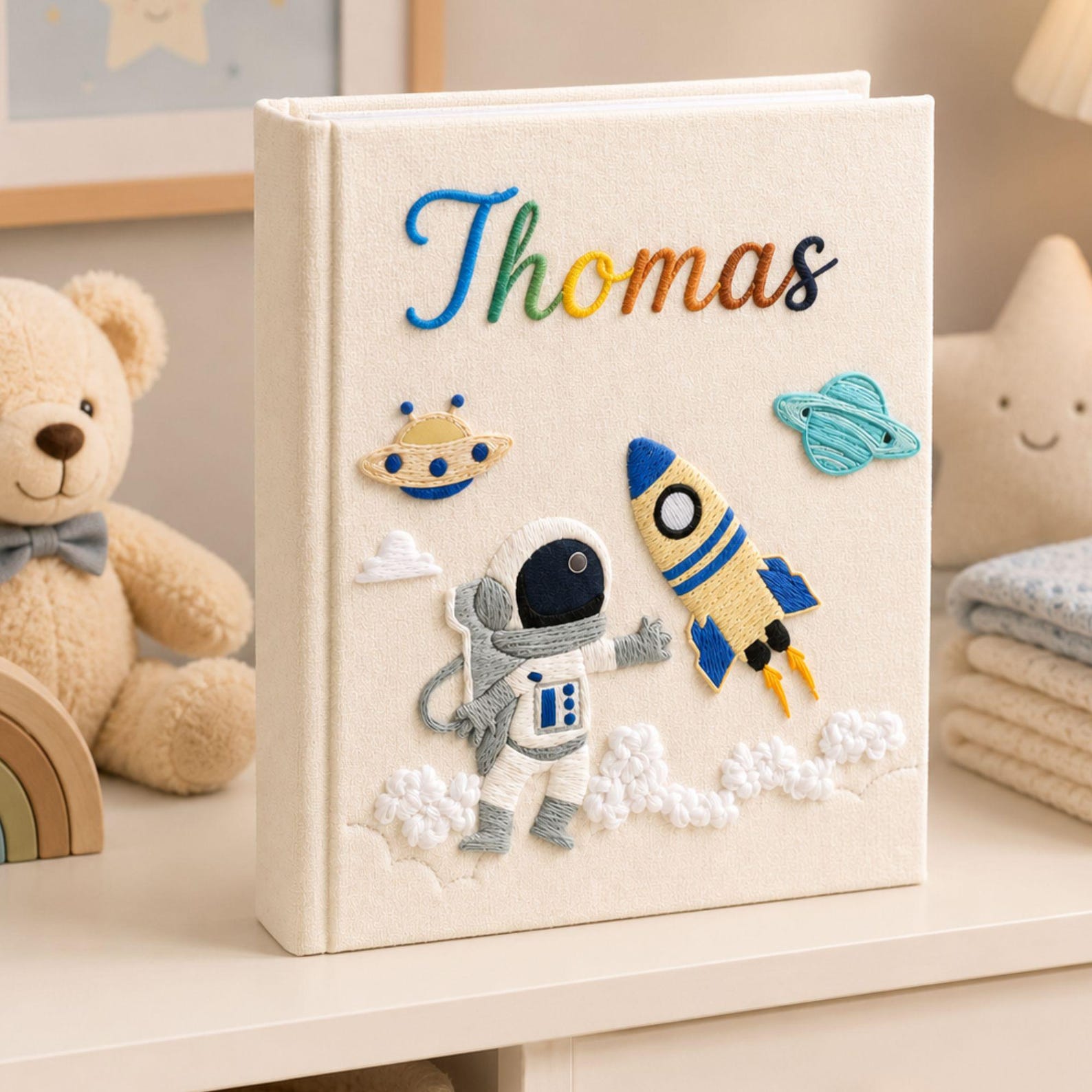 Personalized hand embroidered photo album featuring astronaut rocket ship planets and custom baby name on linen cover