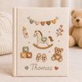 Personalized baby toys hand embroidered photo album with rocking horse teddy bear and nursery accessories on linen cover