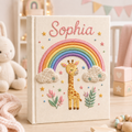 Personalized hand embroidered photo album featuring a pastel giraffe under a rainbow with clouds stars and nursery themed embroidery