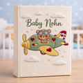 Personalized hand embroidered photo album featuring a teddy bear pilot flying a vintage airplane with clouds and stars