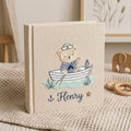 Personalized hand embroidered baby photo album with sailor teddy bear rowing a boat in a nautical nursery theme