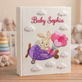 Personalized hand embroidered photo album featuring a bunny flying a purple airplane with heart-shaped balloons and fluffy clouds
